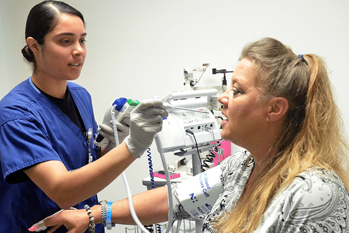 Healthcare worker taking a patient's vital signs