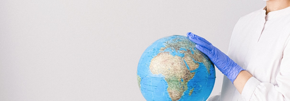 Nurse holding a globe