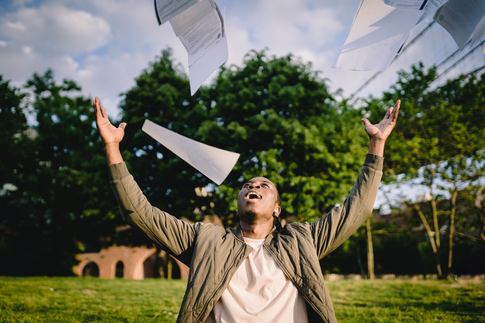 Student throwing paperwork in the air