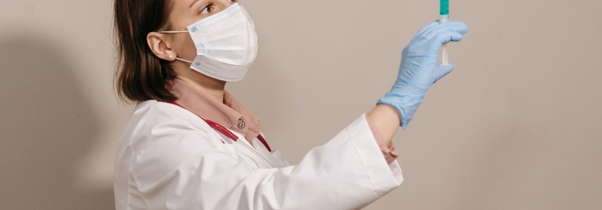Medical professional holding a syringe