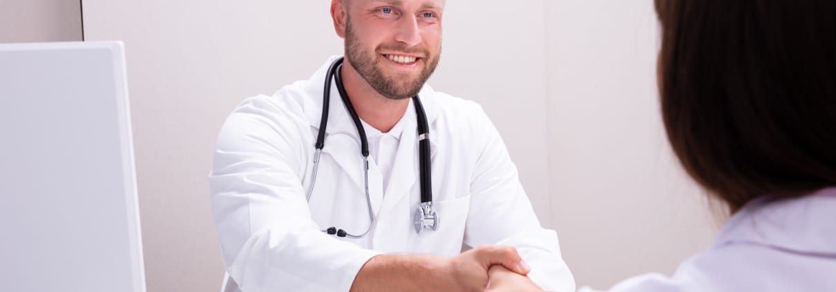 Health professional shaking a woman's hand