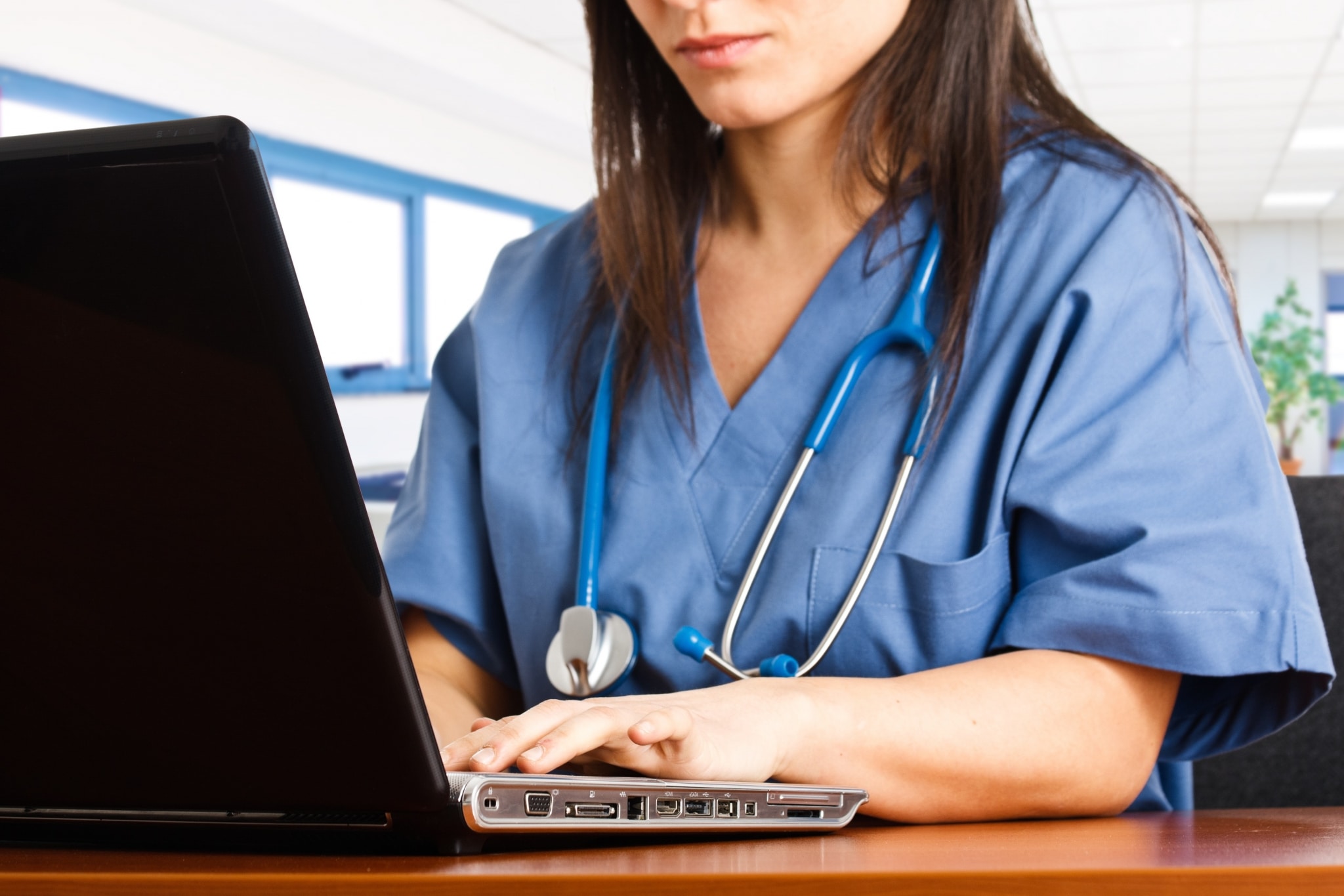 Close up of a nurse on a laptop