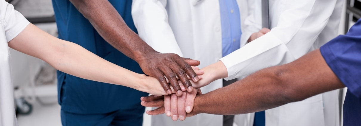 Medical professionals touching hands