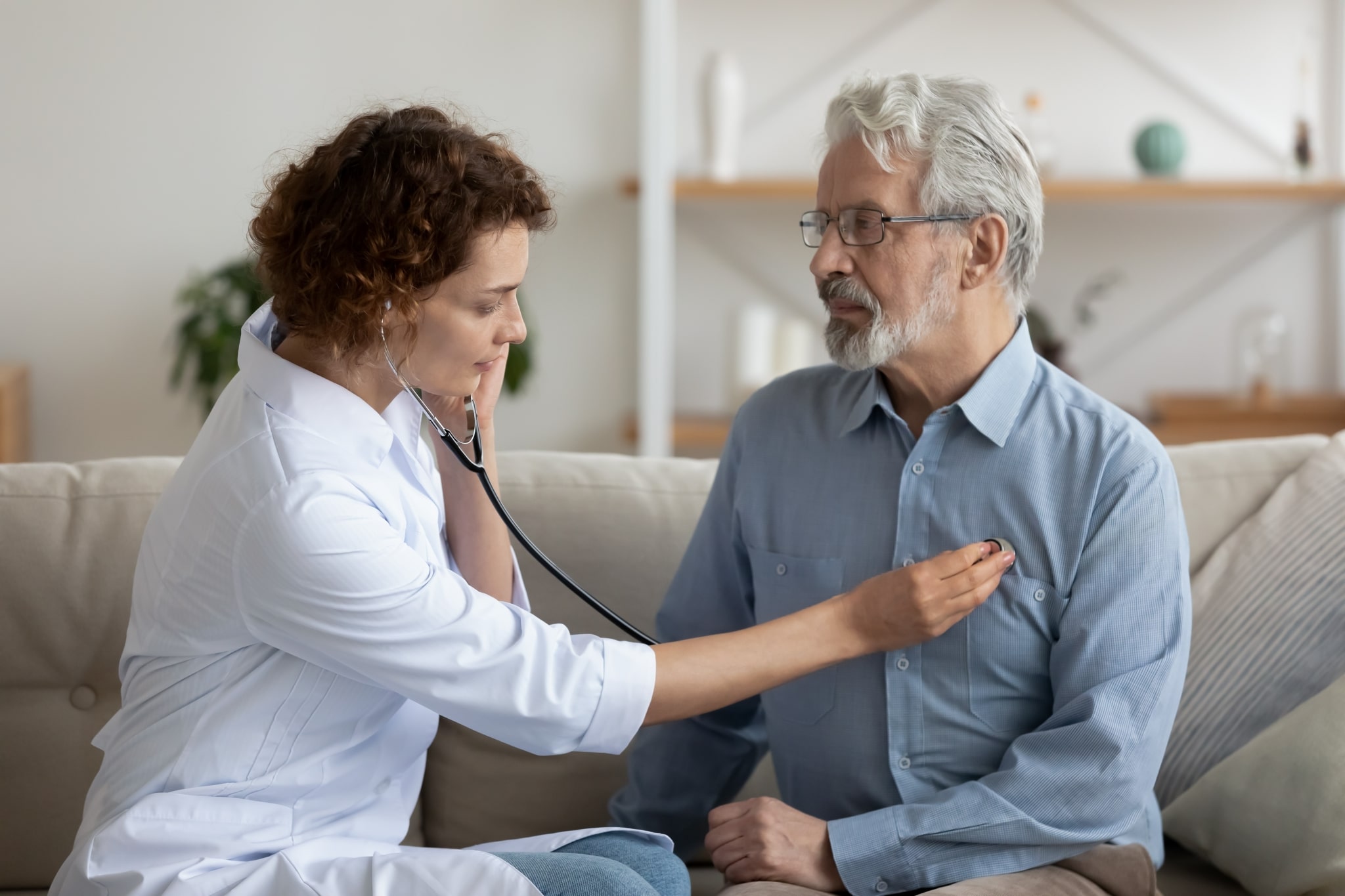 Healthcare professional checking a patient's heartbeat