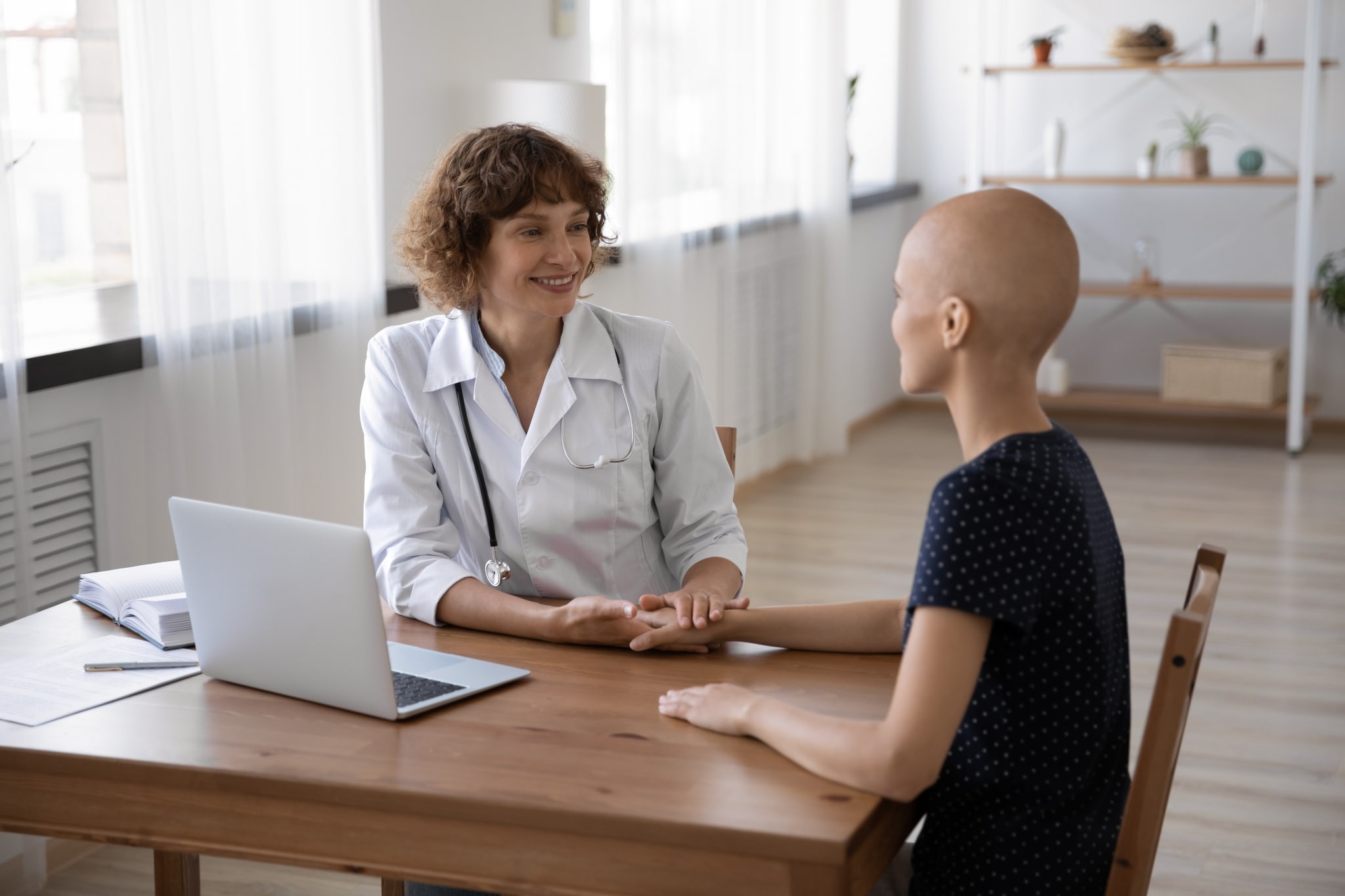 Healthcare professional speaking with a cancer patient