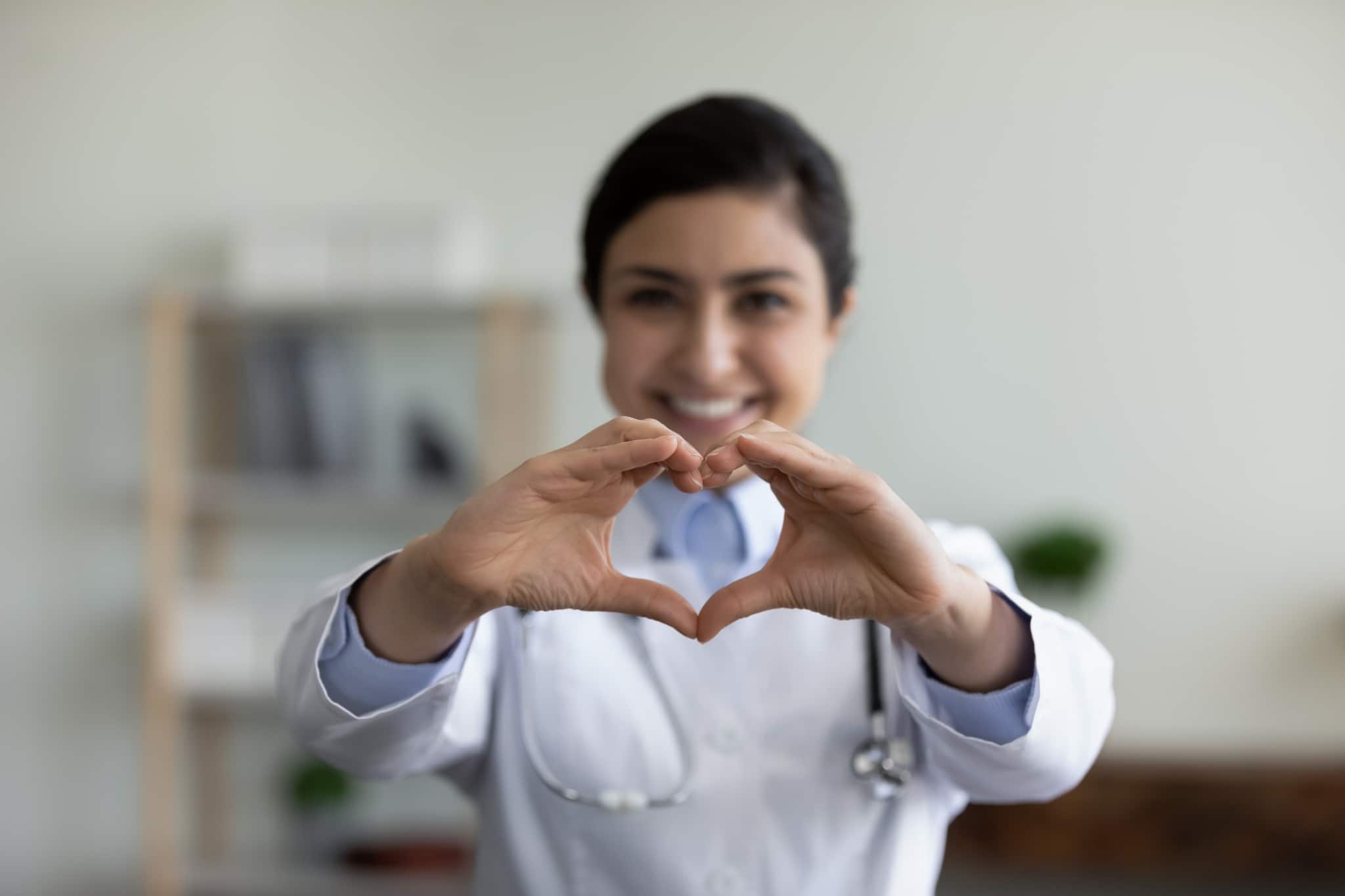 Healthcare professional making a heart sign