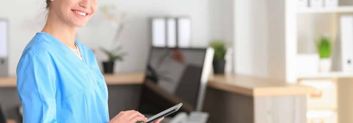 Young healthcare worker holding a tablet