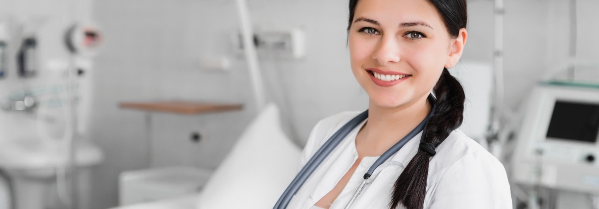 Nurse standing in front of a hospital bed