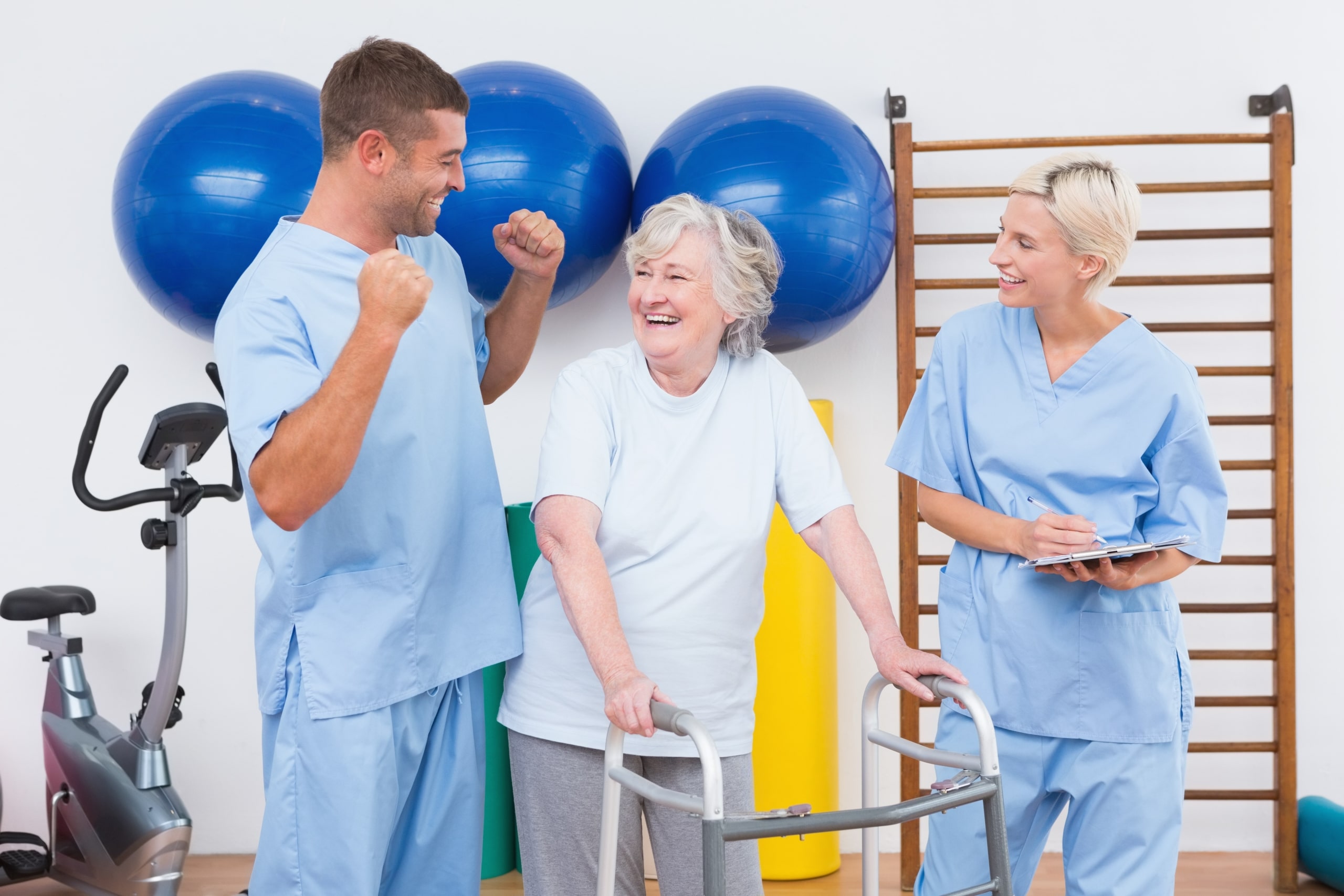 Physical therapy team with elderly patient