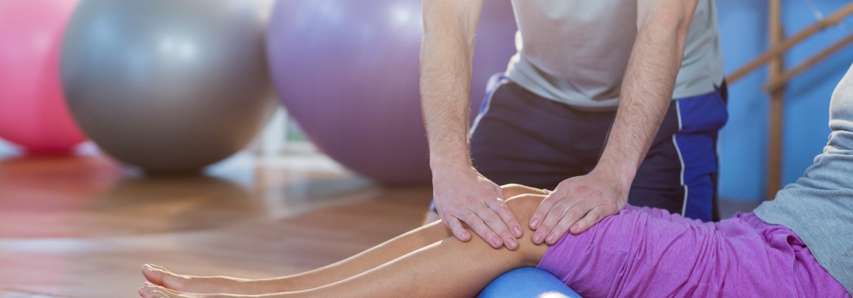 Physical Therapist Assistant manipulating a patient's legs