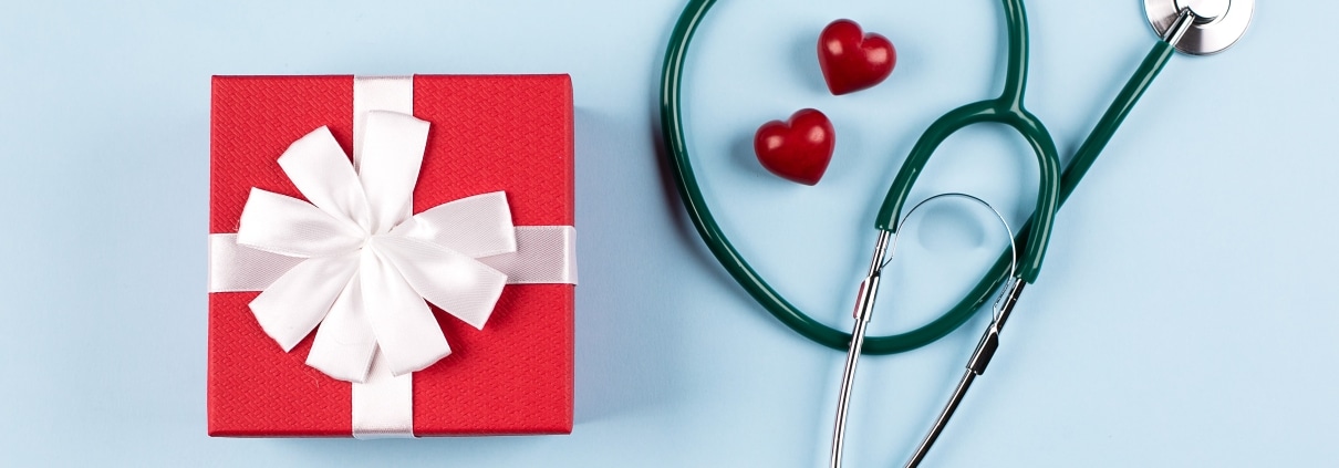 Stethoscope and present on blue background