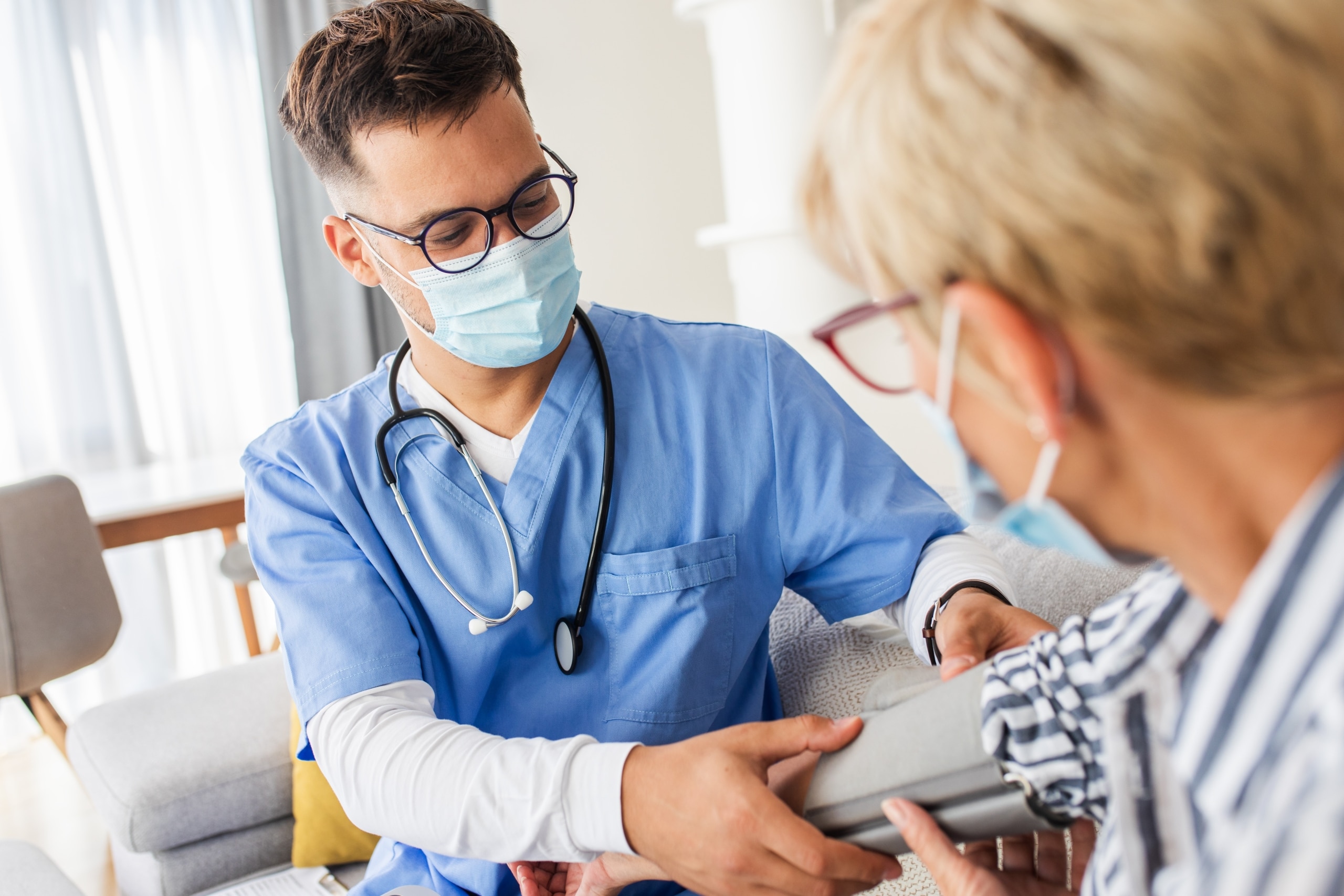 Male nurse measures a patient's blood pressure