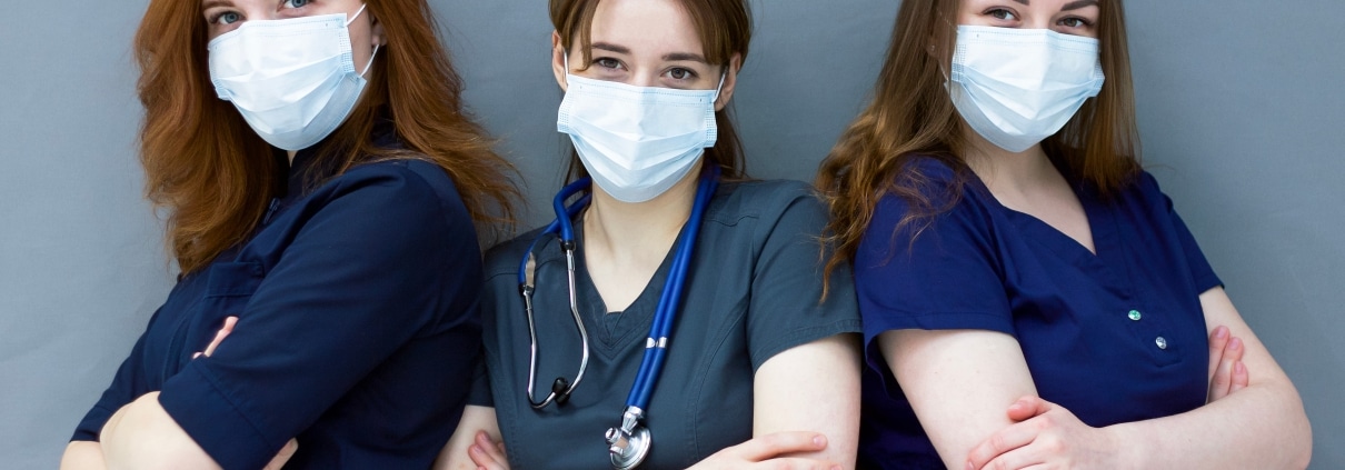 Trio of young masked nurses