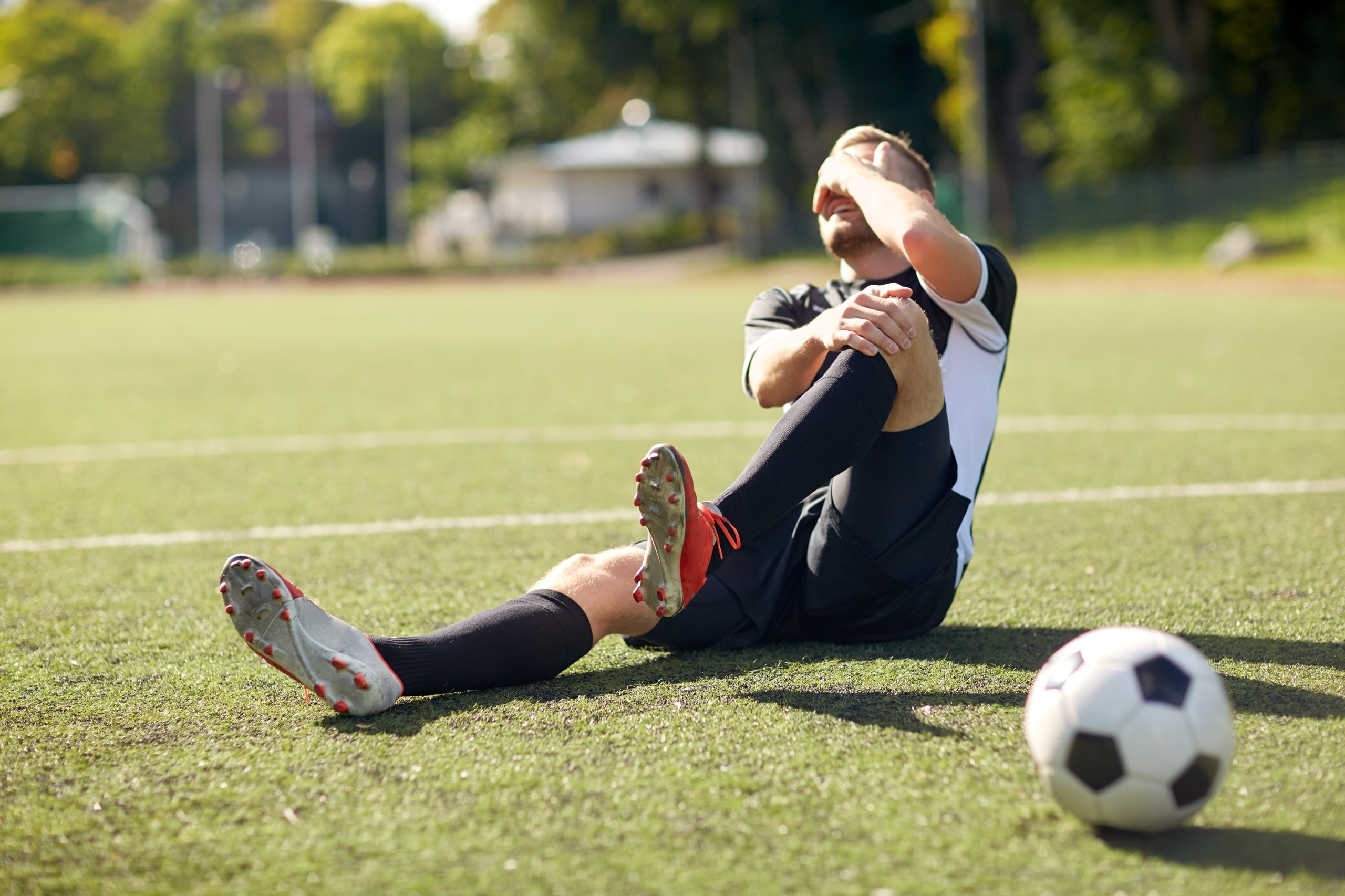 Man playing soccer with sports injury