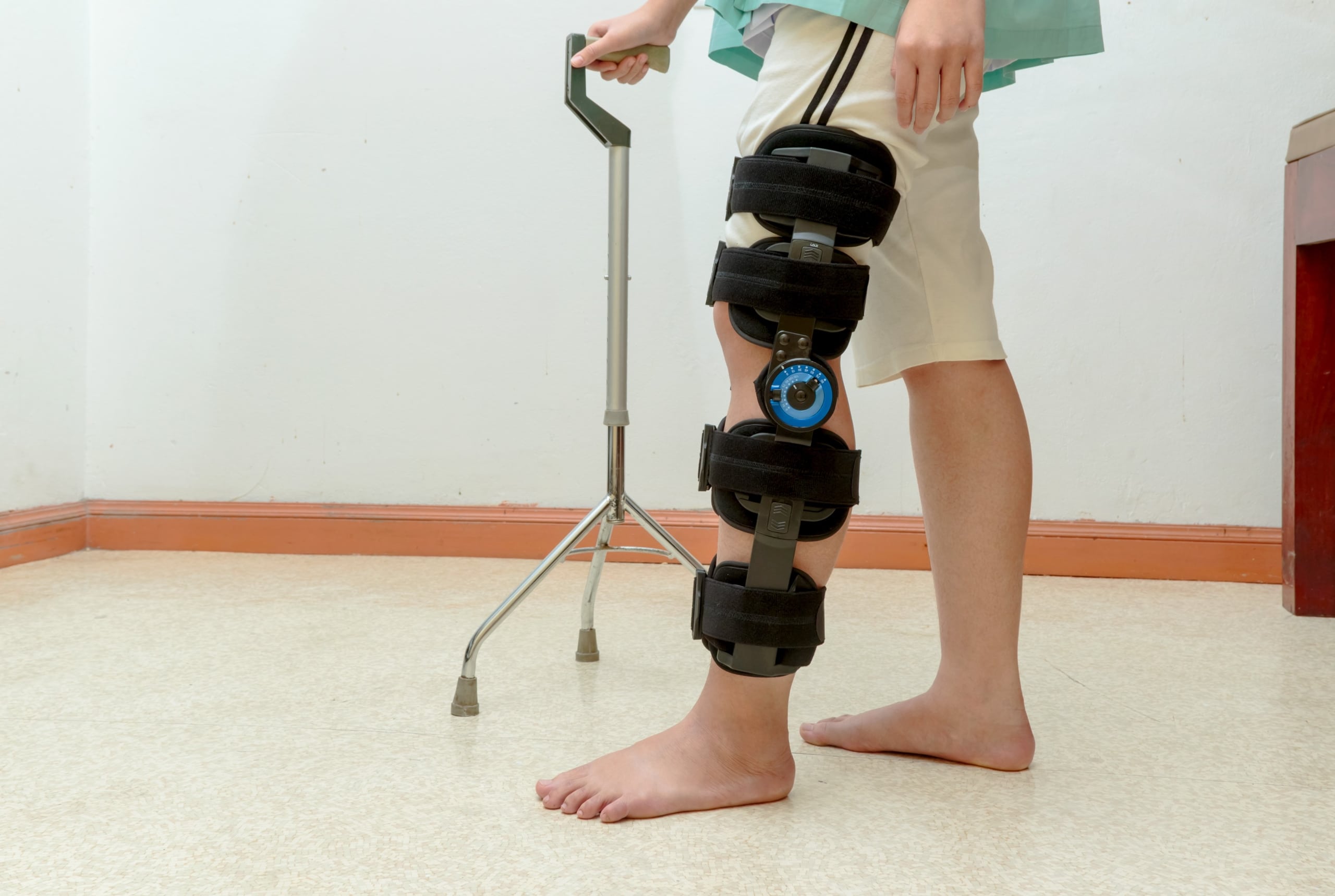 Patient using crutches and knee support