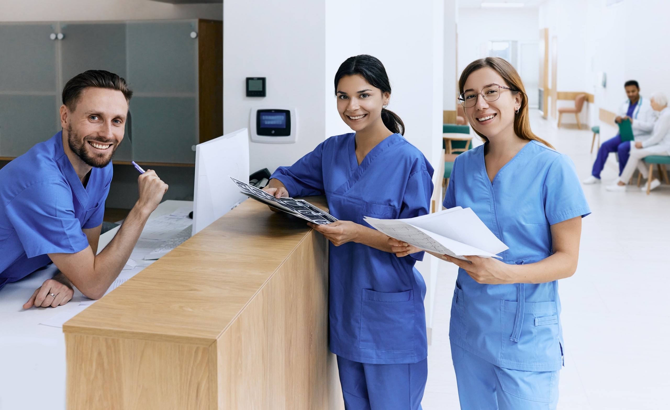 Nurses speaking together at a desk