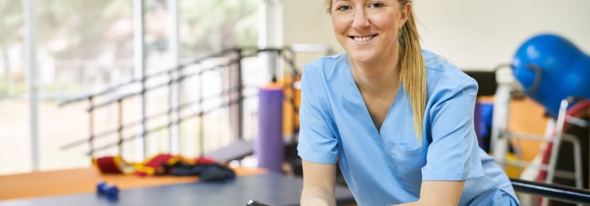 Smiling physical therapist assistant