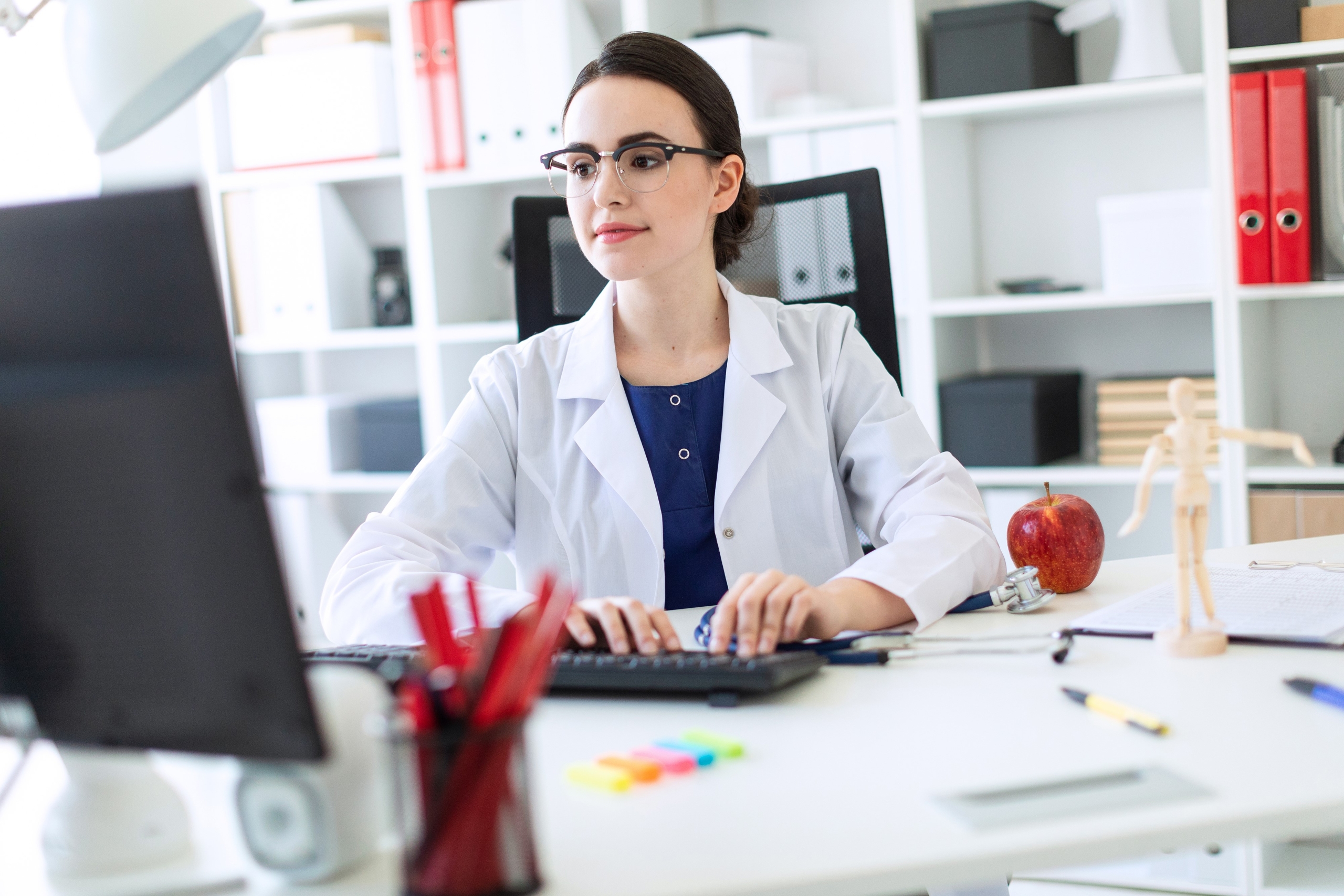 Woman wearing glasses using a computer