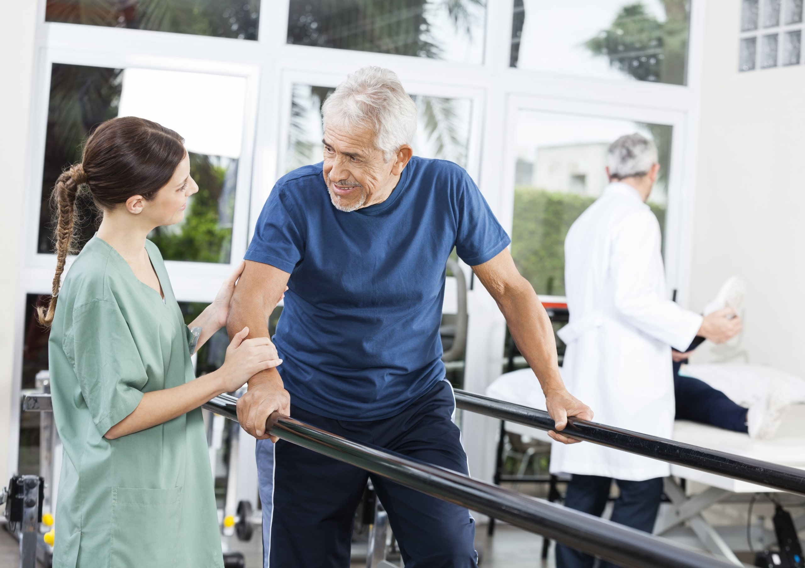 Elderly patient doing gait training exercises in physical therapy