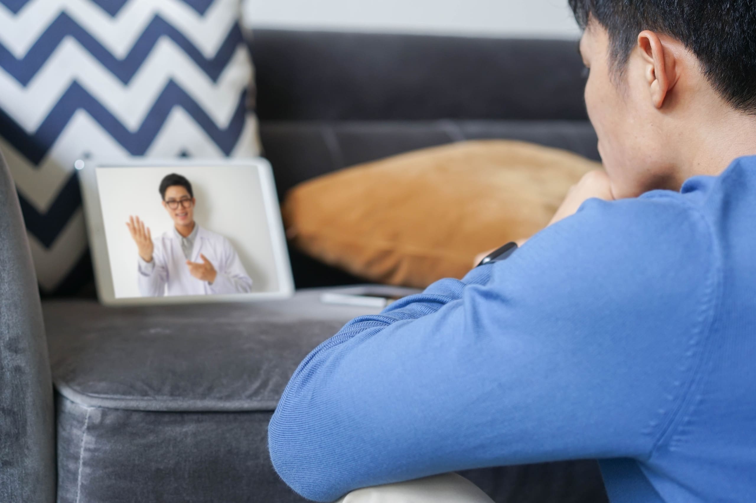 Asian man in a video telehealth appointment