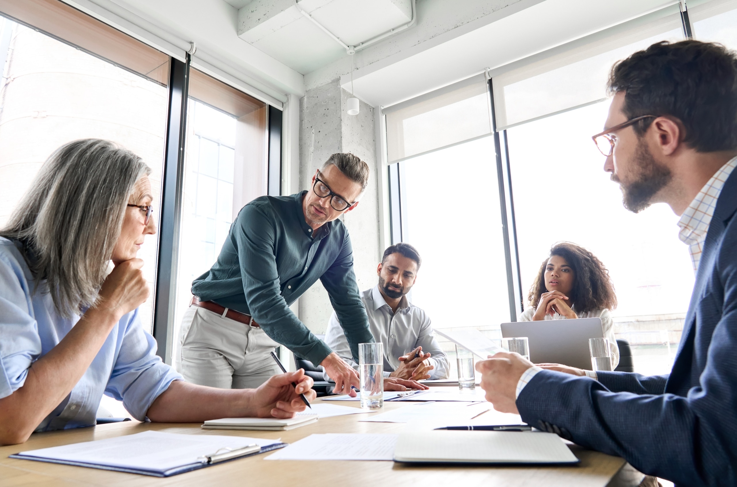 Group of serious business professionals at a conference table