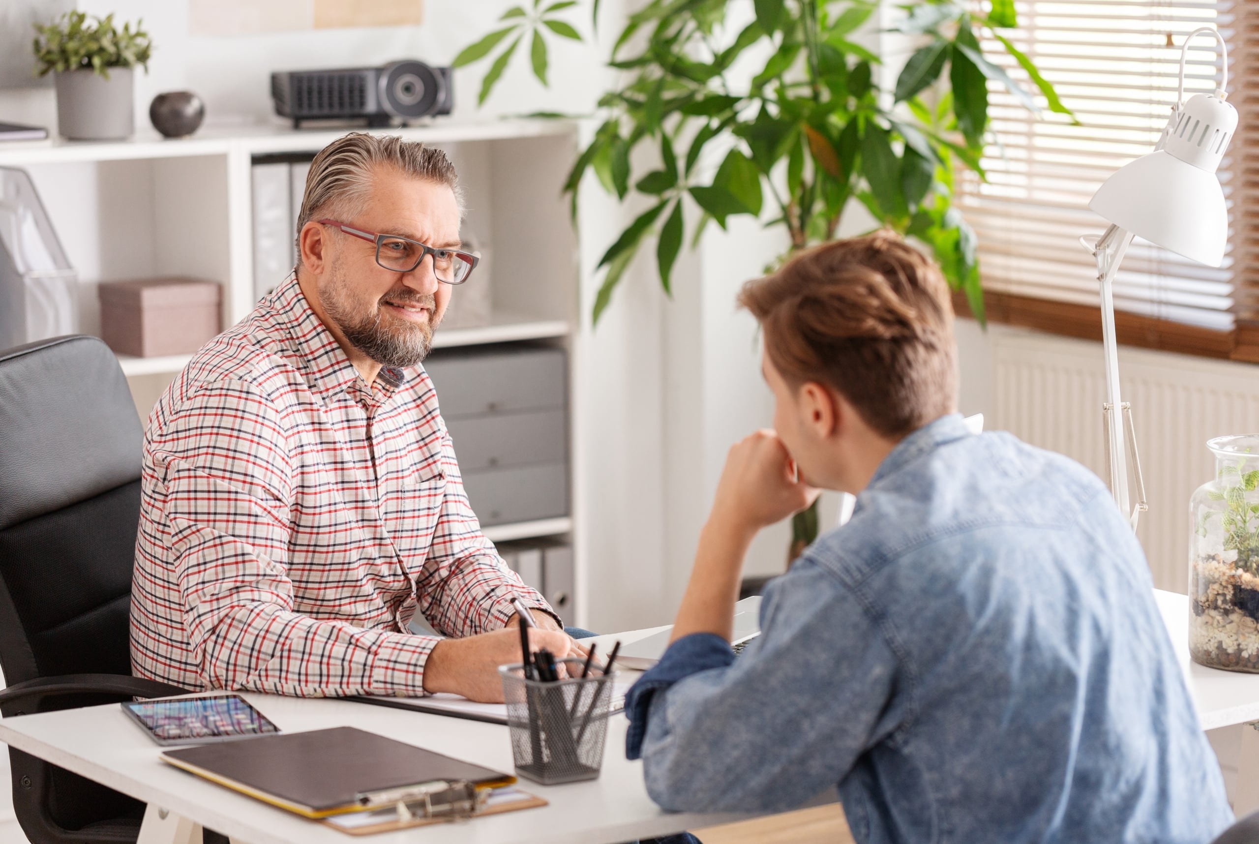 Two men in an office discussing opportunities