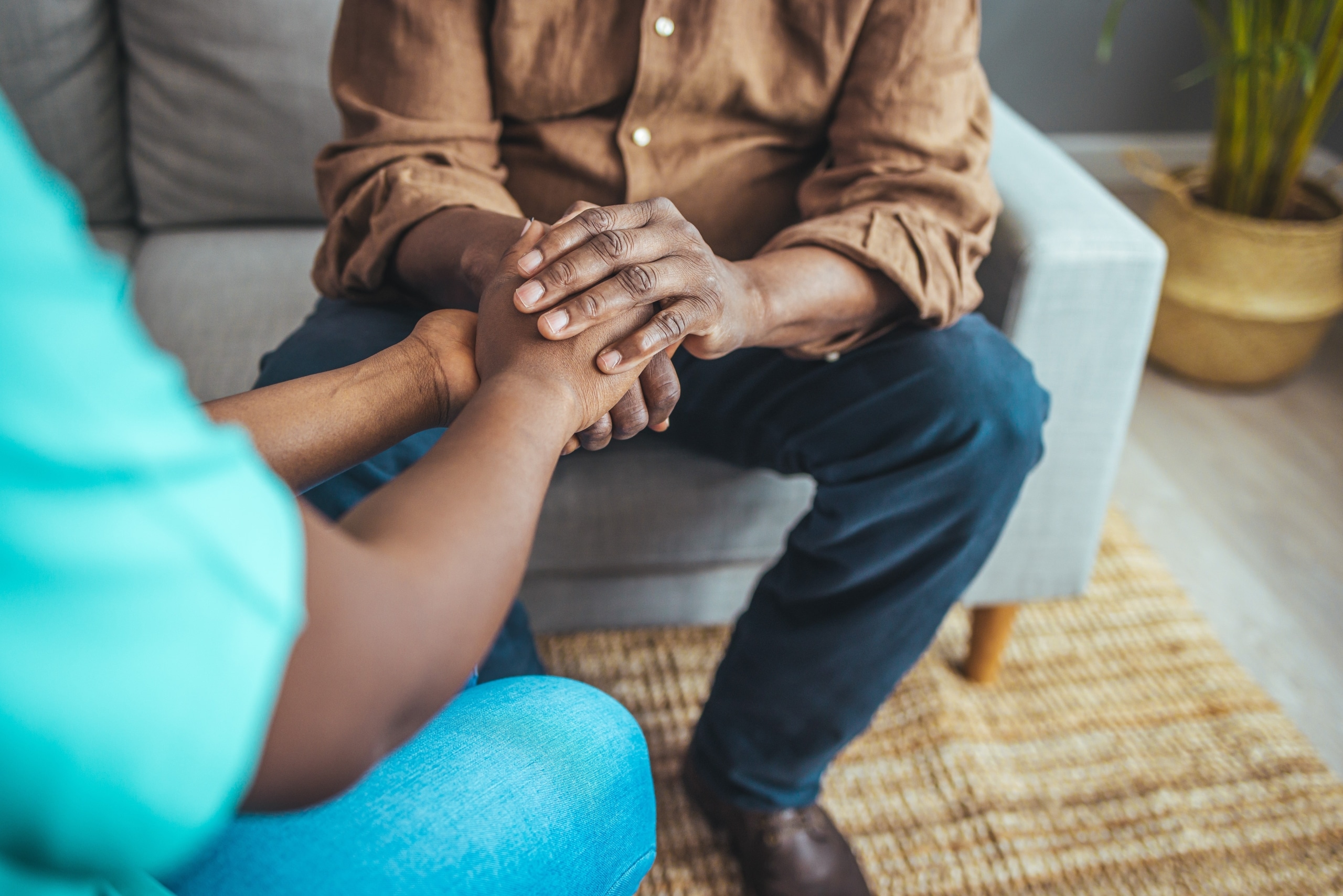 Close up of a nurse holding the hands of a patient