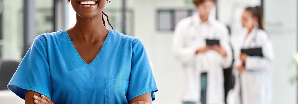 Beautiful African-American nurse in blue scrubs