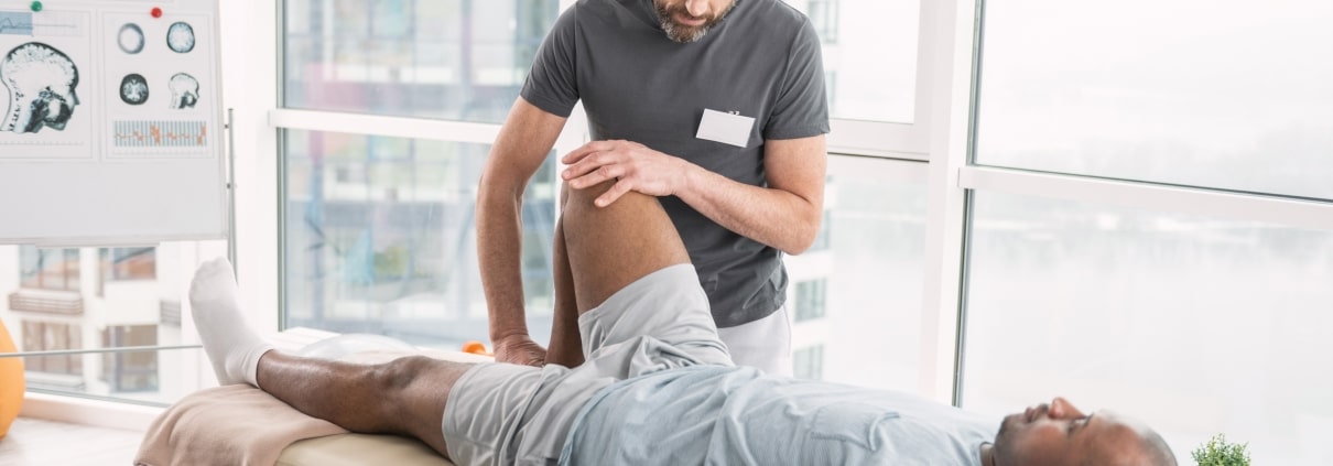 Physical therapy professional examining a patient