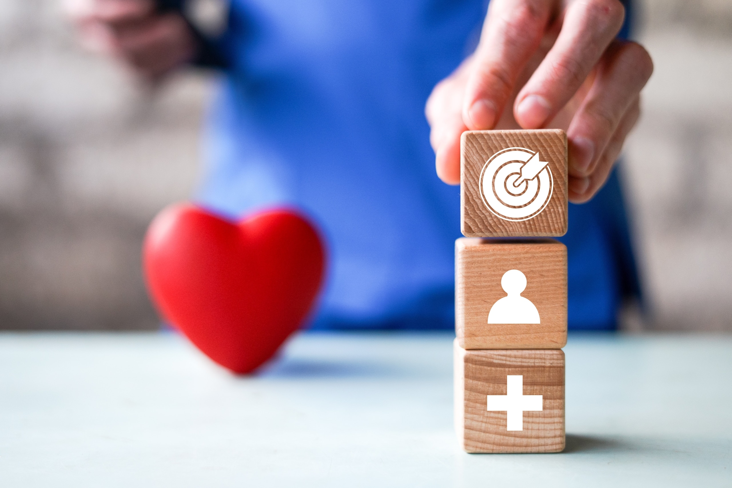 Close up of a nurse stacking blocks with healthcare symbols
