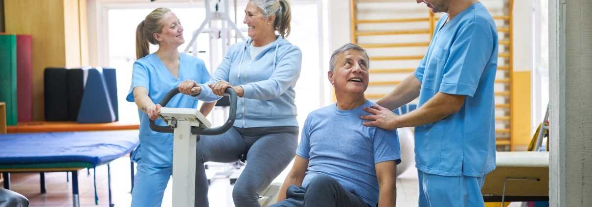 Older patients performing exercises at a physical therapy clinic