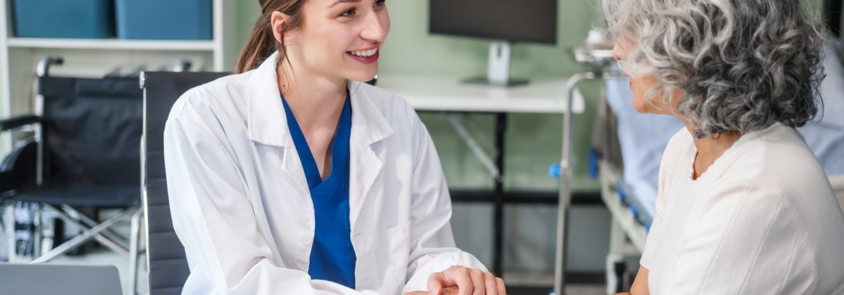 Beautiful medical professional speaking with an older patient