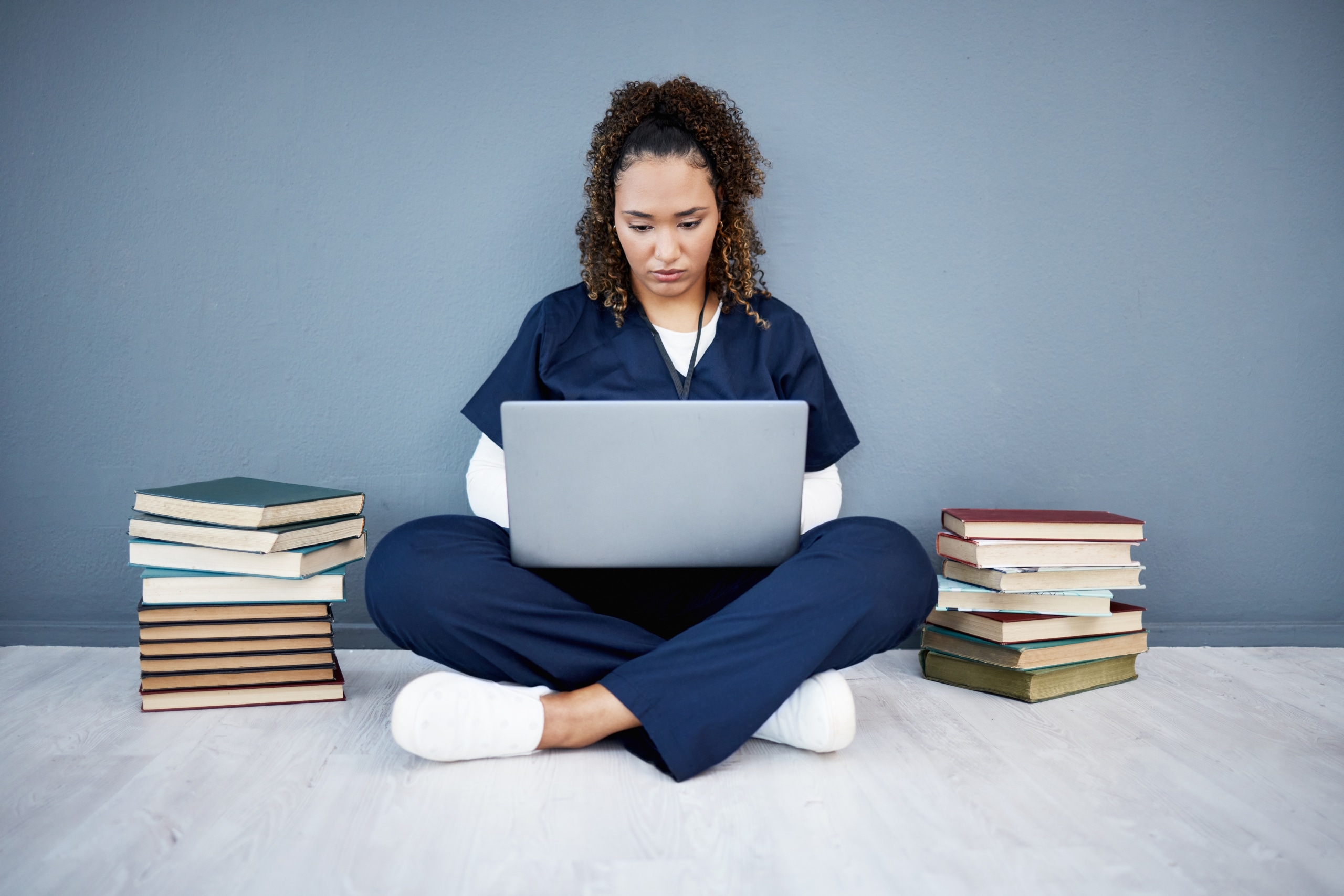 African-American nurse typing on a laptop