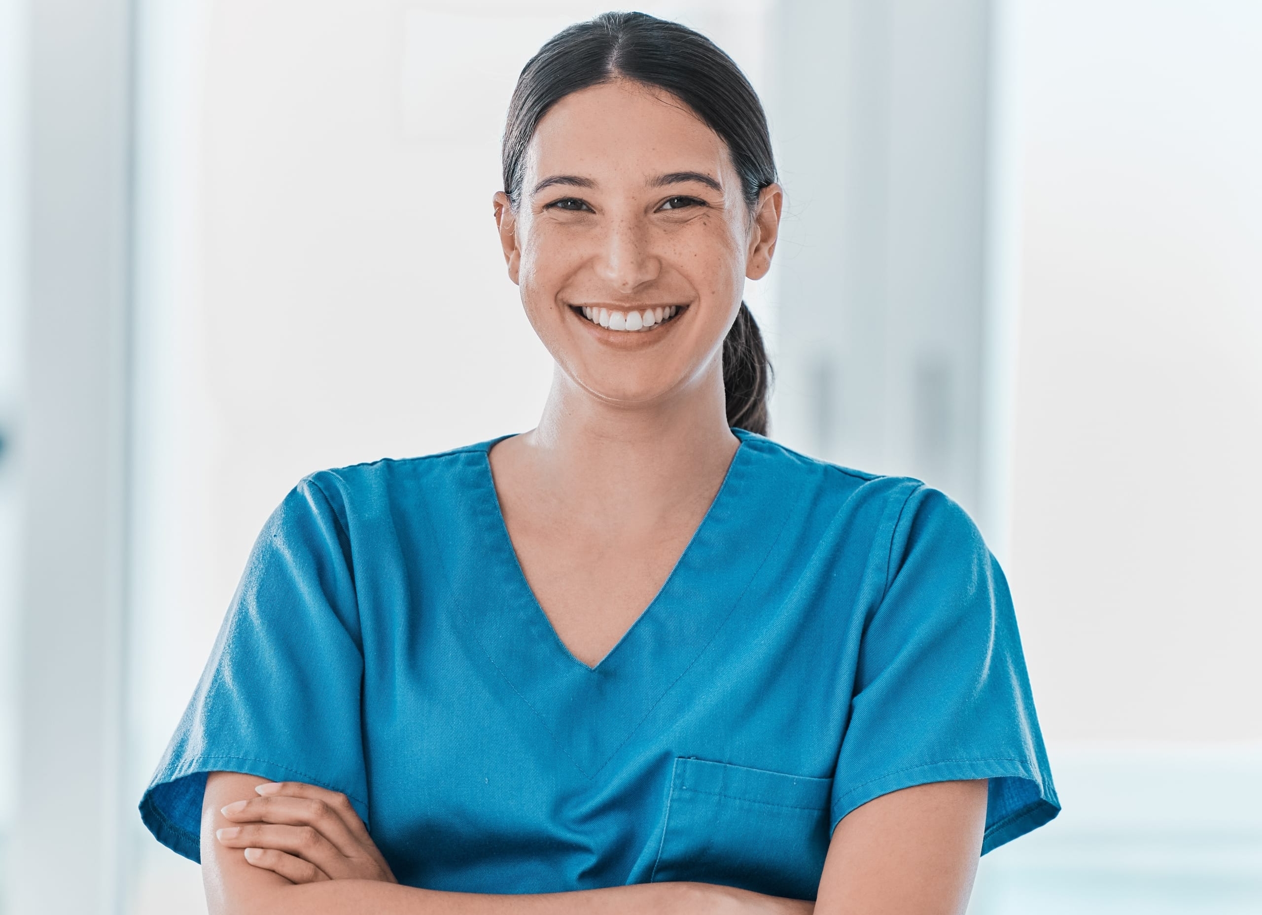 Portrait of a smiling nurse with their arms crossed