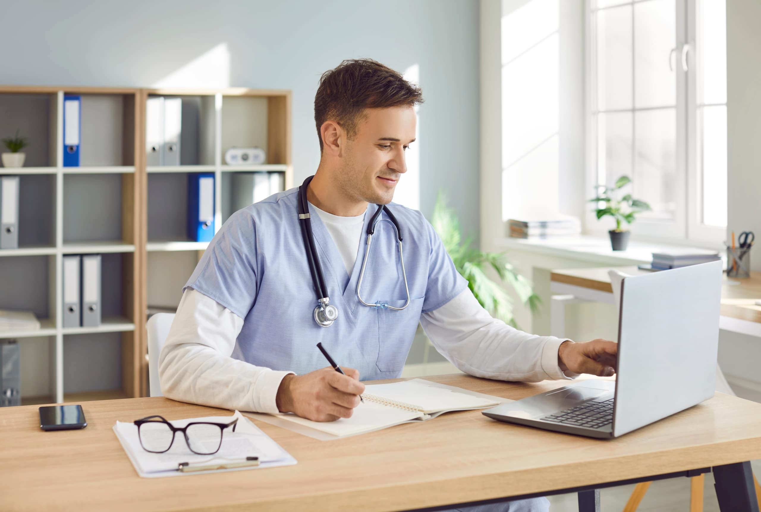 Portrait of a male nurse using a laptop