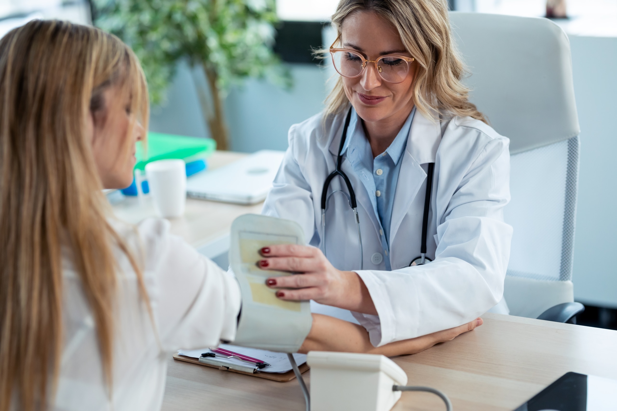Female medical professional taking a woman's blood pressure