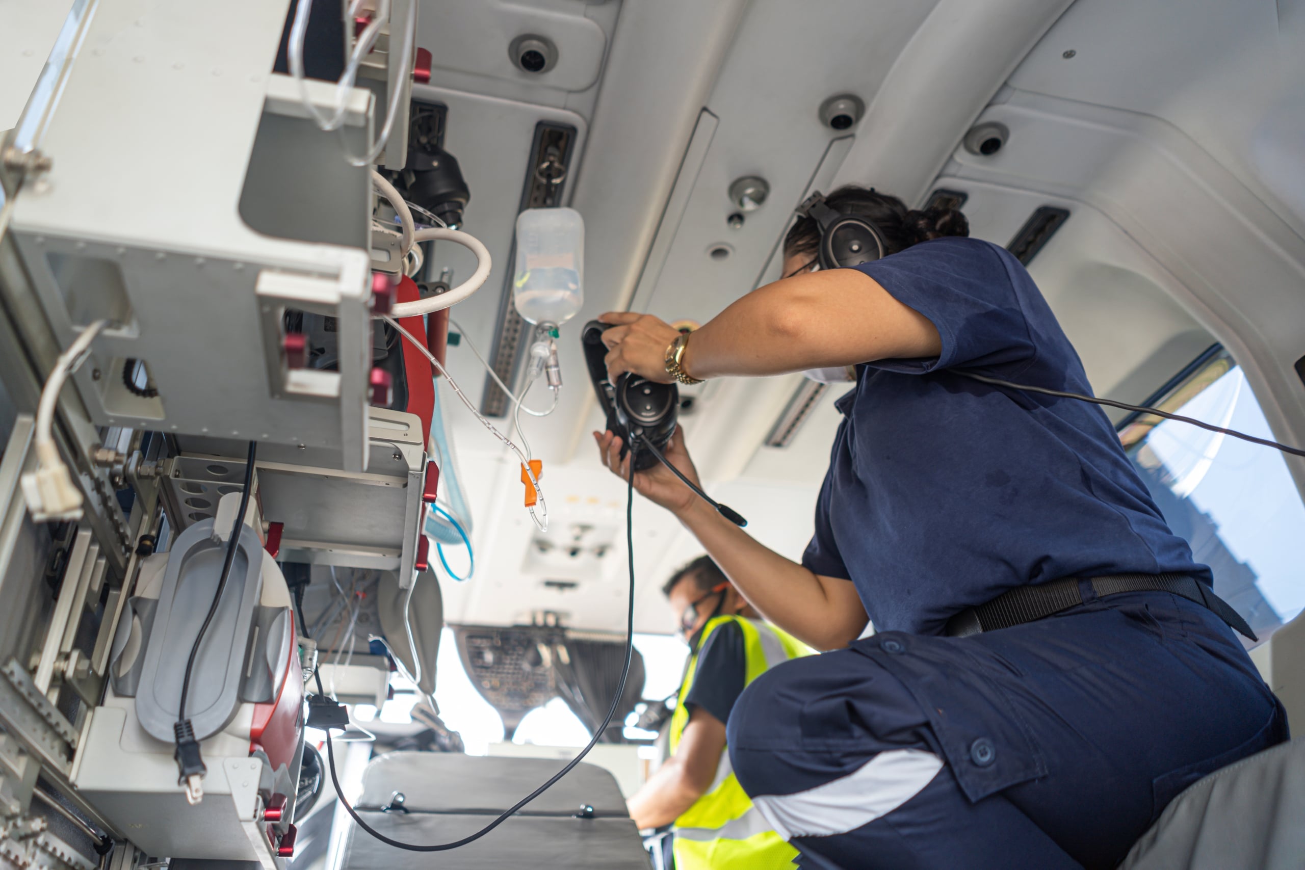 Healthcare professional operating equipment in a medical helicopter