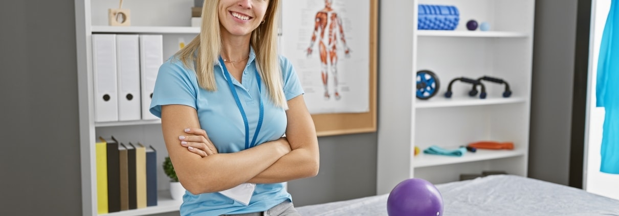 Blonde woman sitting in a physical therapy clinic