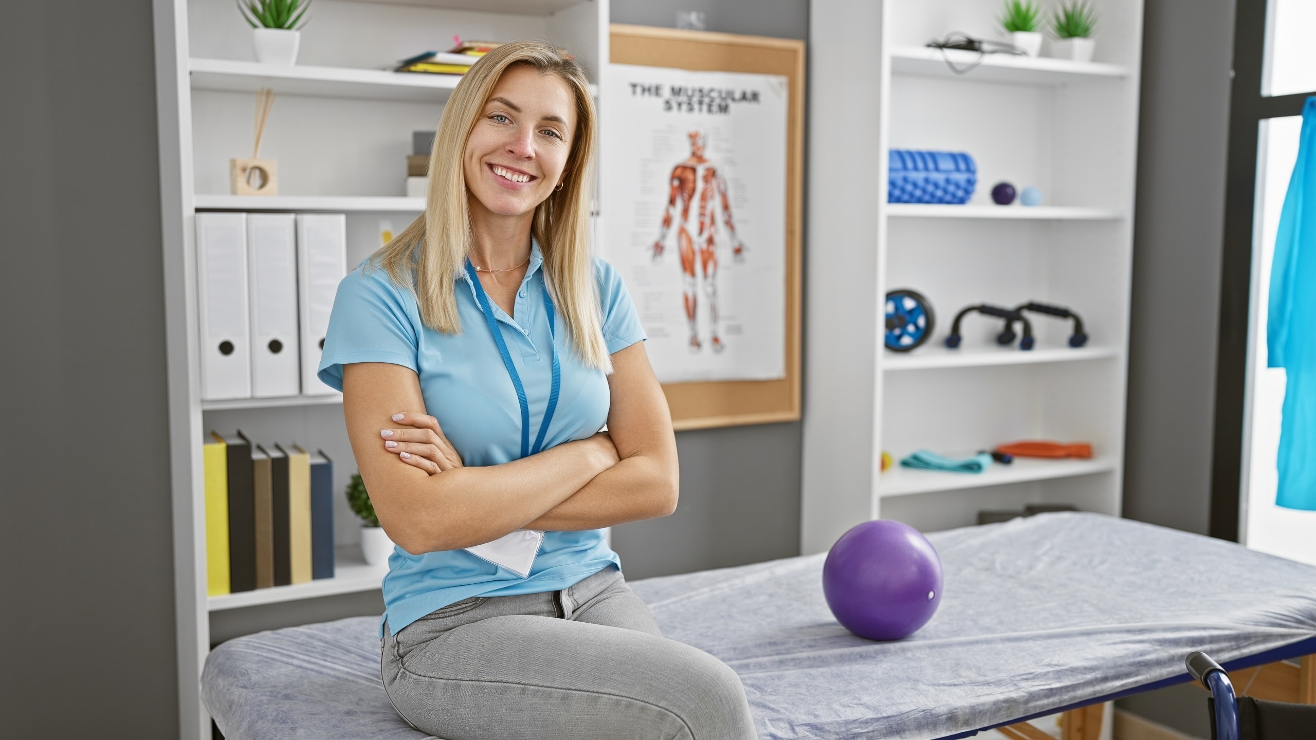 Blonde woman sitting in a physical therapy clinic