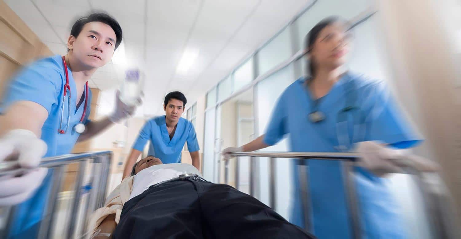 Blurred nurses rushing to transport a patient